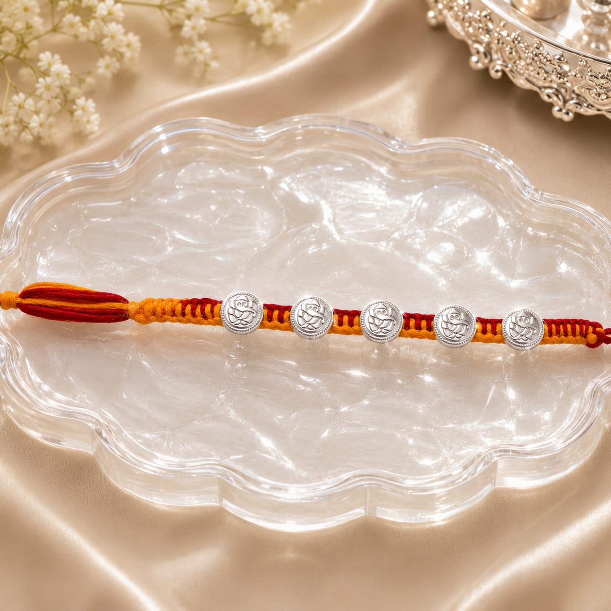 Silver Lord Ganesha Rakhi – Divine Ganpati Charm on Traditional Red & Yellow Thread