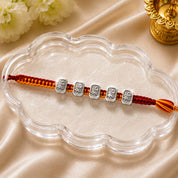 Silver Shri Rakhi – Auspicious Shri Charm on Traditional Red Thread