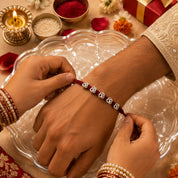 Silver Om Rakhi – Sacred Om Charm on Handwoven Maroon Thread