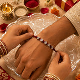 Silver Om Rakhi – Sacred Om Charm on Handwoven Maroon Thread